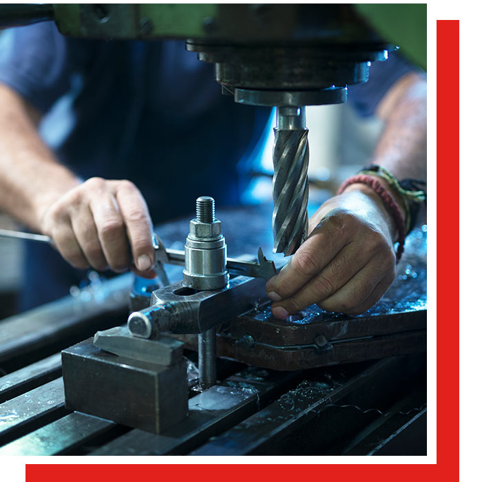 Worker operating industrial drill